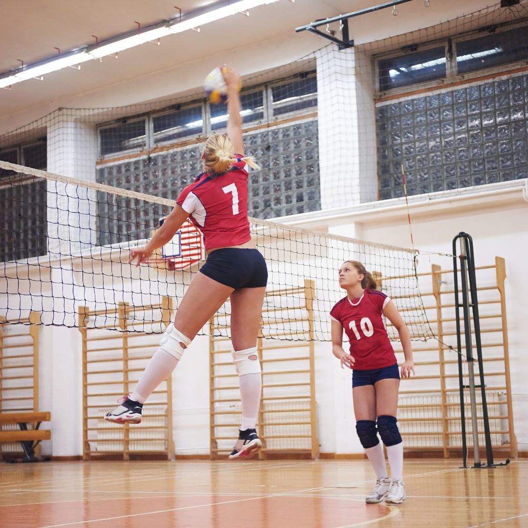 The best pain relief roll on for volleyball players, two women playing volleyball on court